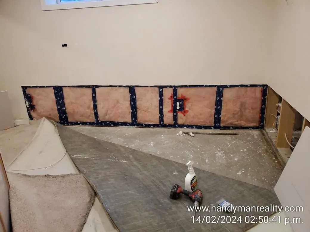 Wall opened at floor level for repair, before closing it up