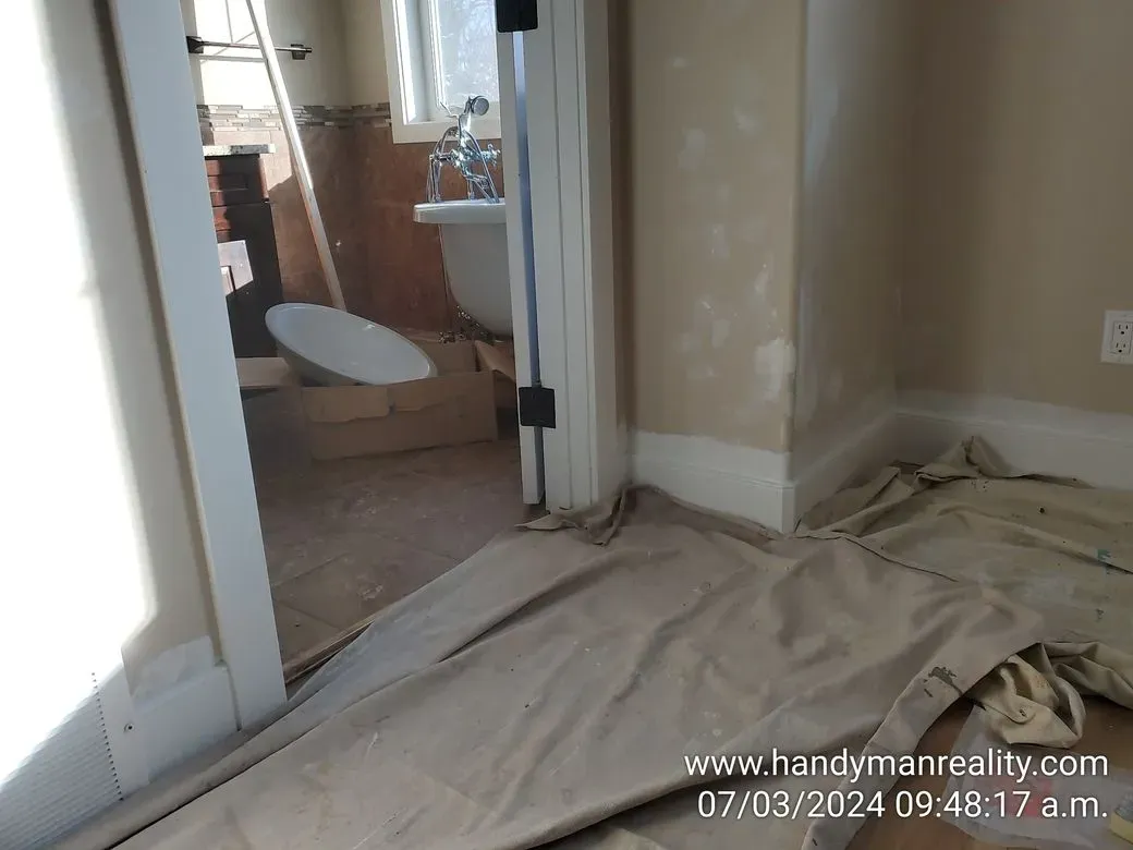 Bathroom repair underway, floors protected with drop sheets