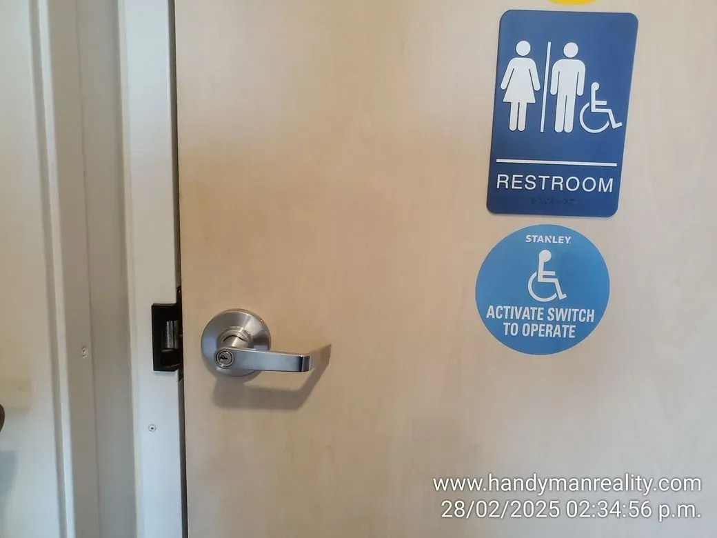 Accessible restroom door hardware and signage — commercial job